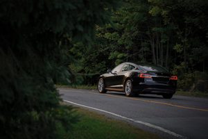 electric car driving through the countryside and nature