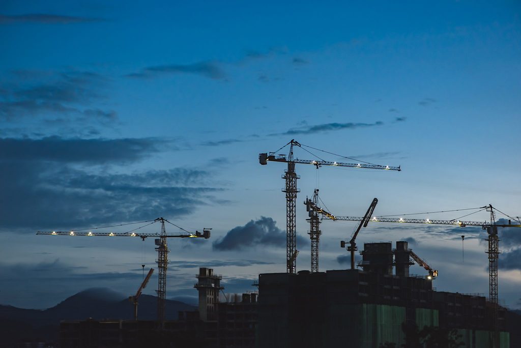 green space sustainability body image 4 - cranes working against a night sky