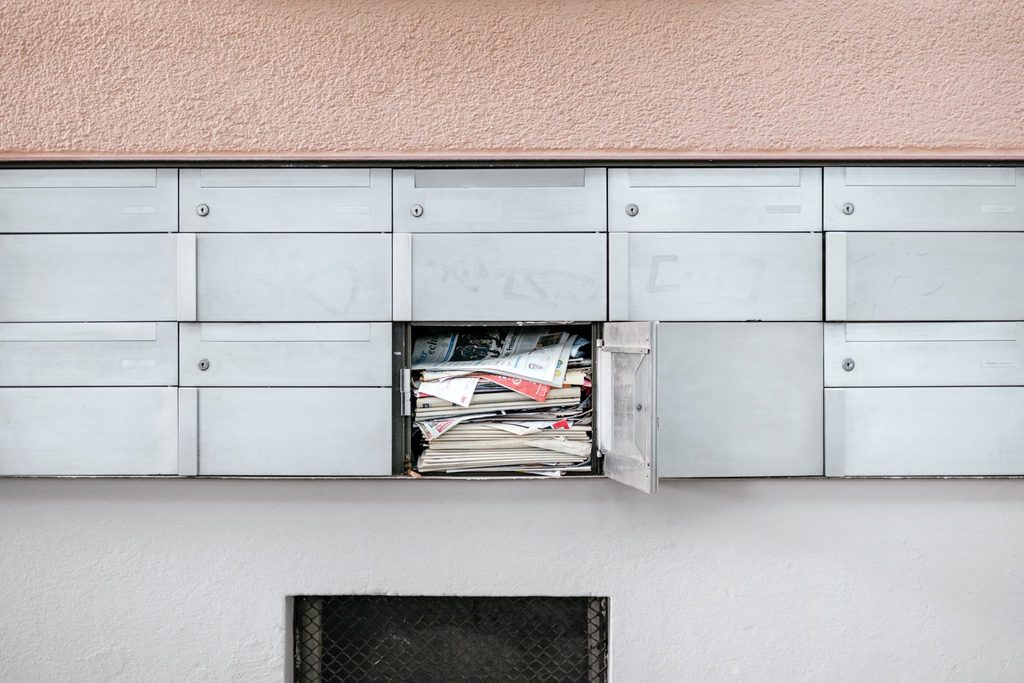 sustainability and mental health body image 3 locker with one open and full of junk mail