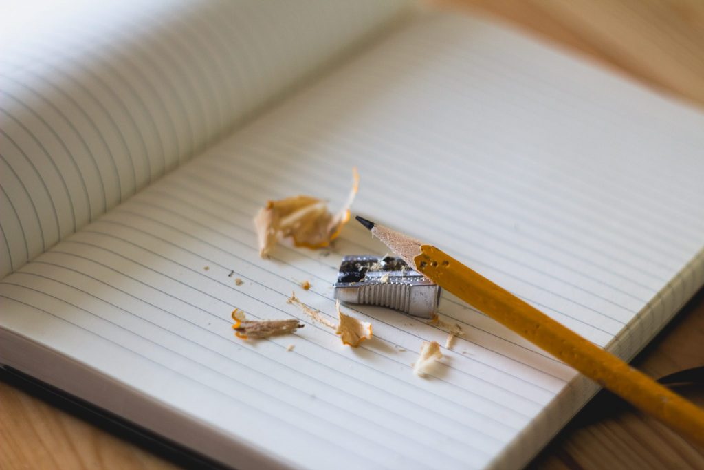 A pencil and sharpener placed on an education centred notebook