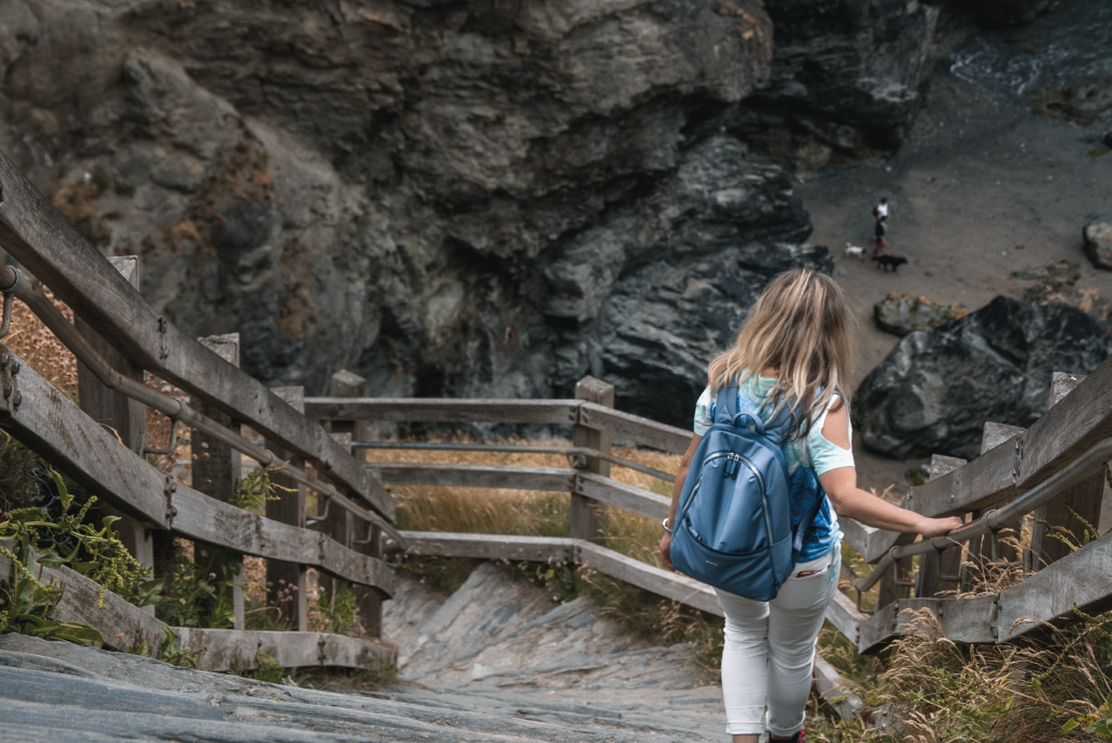 A tourist area in Cornwall. Woman walking down the steps towards the future of the visitor economy