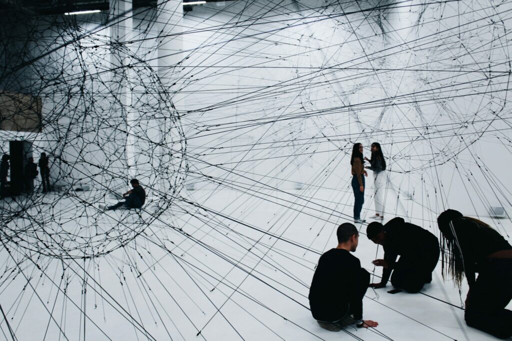 An immersive exhibition at a museum with people interacting with the art