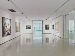 image of a museum displaying works of art. It is an open and quiet space.